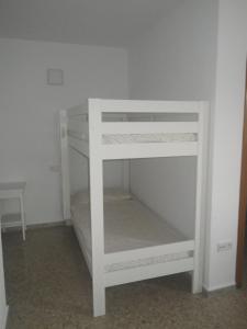 a white bunk bed in a room at Cal toà in Coll de Nargó