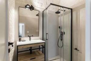 a bathroom with a sink and a shower at Petragrigia Vacation Suite in Ostuni +19 photos