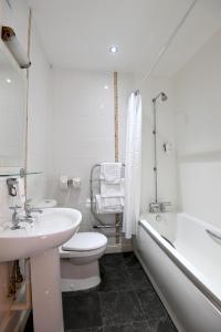 a bathroom with a sink and a toilet and a tub at Admiral's Table, Bridgwater by Marston's Inns in Bridgwater
