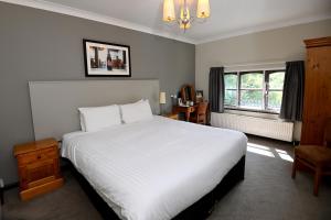 a bedroom with a large white bed and a window at Admiral's Table, Bridgwater by Marston's Inns in Bridgwater