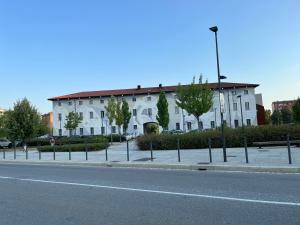 a white building on the side of a street at Sweet Home in Milano smart district in Milan