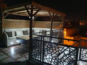 a gazebo with a couch and a table at Dar Malika in El Jadida