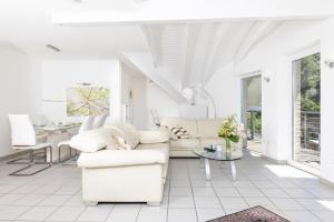 a white living room with white furniture and a table at Sonnendeck4 in Siegen