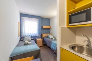 Postel nebo postele na pokoji v ubytování Residencia Universitaria Resa La Ciutadella
