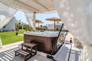 a hot tub on the patio of a house at Heliophos Villa Amalthia in Kiotari