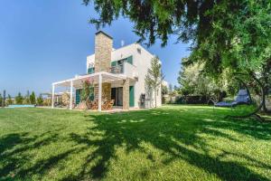 an image of a house with a yard at Heliophos Villa Amalthia in Kiotari