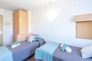Postel nebo postele na pokoji v ubytování Residencia Universitaria Resa La Ciutadella