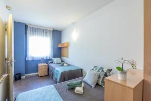 Postel nebo postele na pokoji v ubytování Residencia Universitaria Resa La Ciutadella