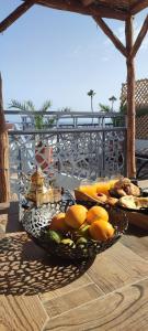 a bowl of fruit on a table on a deck at Dar Malika in El Jadida