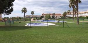 an empty park with a playground with swings at PINAR RESORT in Sant Jordi