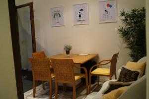 a wooden table and chairs in a room at Archimede Guest House in Brussels