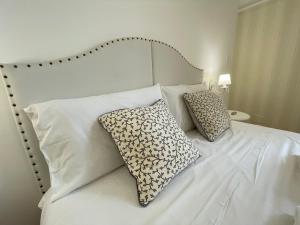 a white bed with two pillows on top of it at Domus Bianca Lancia in Manfredonia