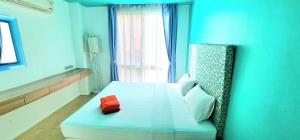 a blue room with a bed and a window at Atlantis Condo Resort GP in Jomtien Beach +54 photos