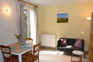 a living room with a table and a couch at Domaine de Courbieres in Laurac