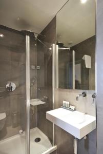 a bathroom with a sink and a shower at Villa Des Princes in Paris