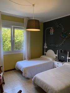 Postel nebo postele na pokoji v ubytování Hotel Bayona