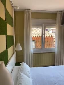 Postel nebo postele na pokoji v ubytování Hotel Bayona