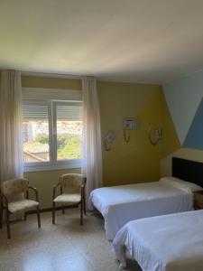Postel nebo postele na pokoji v ubytování Hotel Bayona