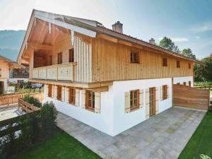 una gran casa de madera con un gran patio trasero en Natur pur - Doppelhaushälfte im idyllischen Kreuth en Kreuth