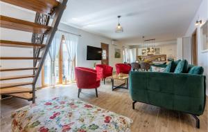 a living room with a green couch and red chairs at Lovely Home In Grizani With Kitchen in Grižane