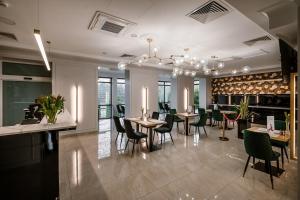 a dining room with tables and chairs in a restaurant at Hotel Polonia in Biała Podlaska