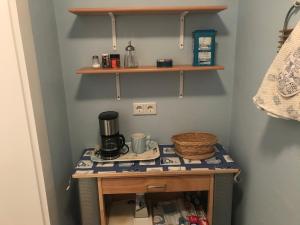 a room with a table with a coffee maker on it at Ferienhaus Fehlhaber in Borkum