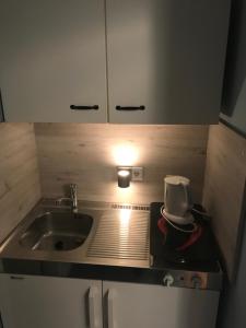 a kitchen with a sink and a hat on the counter at Ferienhaus Fehlhaber in Borkum