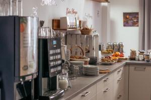 a kitchen with a counter with food on it at REGIOHOTEL Wolmirstedter Hof in Wolmirstedt +23 photos