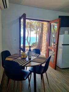 a dining room table with a bottle of wine on it at Apartman Zlatan in Sveta Nedelja