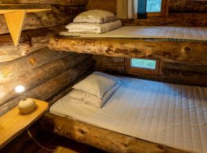 two bunk beds in a log cabin with a table at Arctic Log Cabins in Saariselka