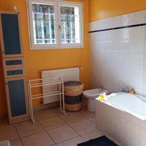 a bathroom with a tub and a toilet and a window at Domaine de Courbieres in Laurac +23 photos