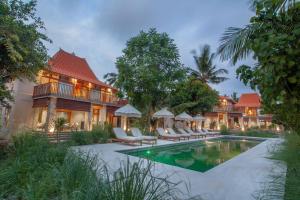 an exterior view of a resort with a swimming pool at Diamond Beach Villas in Nusa Penida