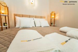 sypialnia z 2 białymi ręcznikami na łóżku w obiekcie Baltic Apartments - Sun Towers w Świnoujściu