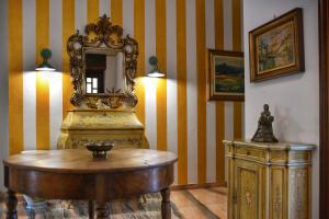 a room with a table and a mirror on a wall at Villa Sequoia in Leinì