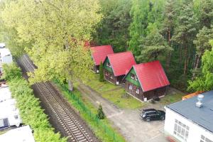 an overhead view of three houses with red roofs at Półwysep Natura Tour in Jastarnia
