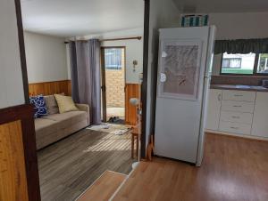 a living room with a couch and a kitchen at Goin Coastal in Busselton