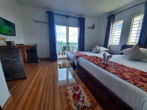 a hotel room with two beds and a fireplace at Realkhom Homestay in Siem Reap