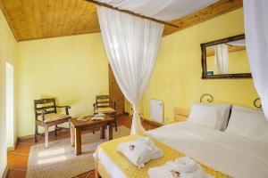a bedroom with two beds and a table and a mirror at Be&See in River in Ovar