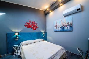 Un pat sau paturi într-o cameră la RELAIS IL CORALLO