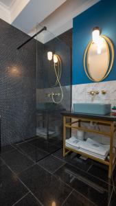 a bathroom with a glass shower and a sink at Mamaia Beach Condos 2 in Năvodari