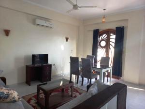 a living room with a couch and a dining room table at Villa Victoria Old Nile View in Luxor