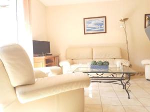 a living room with a couch and a coffee table at Appartement Saint-Lary-Soulan, 4 pièces, 9 personnes - FR-1-457-181 in Saint-Lary-Soulan