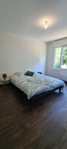a bedroom with a bed in a room with a window at Le circuit in Magny-Cours