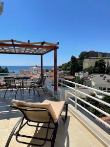 a balcony with chairs and a view of the ocean at Villa Guci in Ulcinj