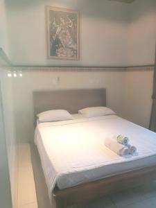 Postel nebo postele na pokoji v ubytování Dewi Antara Homestay