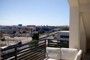 a balcony with white chairs and a view of a city at D8 B&B in Zadar