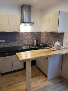 a kitchen with a wooden counter top and a stove at Dom nad Potokiem Dwernik - pokoje z łazienkami in Dwernik +21 photos