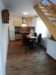 a kitchen and dining room with a table and chairs at Dom - nad Potokiem in Lutowiska