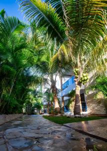 a street with palm trees in front of a building at Stylish 1r-1b Apt Near The Beach And Main Street in Sosúa