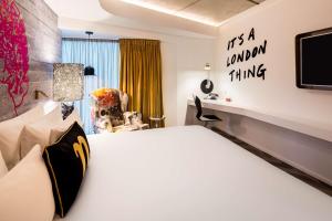 a hotel room with a bed and a tv at nhow London in London